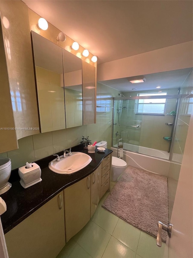 3551 NE 169th St Unit 301, North Miami Beach, FL 33160 - bathroom with enclosed tub / shower combo, vanity, tile patterned floors, tasteful backsplash, and tile walls