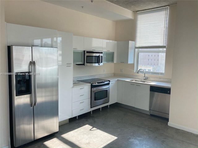 133 NE 2nd Ave Unit 913, Miami, FL 33132 - kitchen featuring appliances with stainless steel finishes, a sink, finished concrete floors, white cabinetry, and light countertops