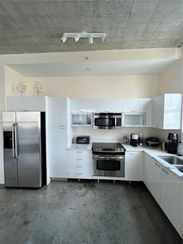 133 NE 2nd Ave Unit 913, Miami, FL 33132 - kitchen with stainless steel appliances, concrete floors, a sink, and white cabinets