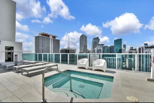 133 NE 2nd Ave Unit 913, Miami, FL 33132 - view of swimming pool featuring a community hot tub, a skyline view, and a patio