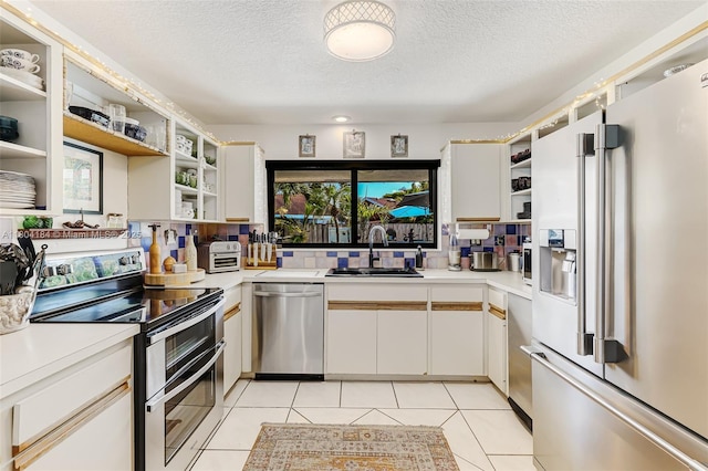 14680 SW 107th Ter, Miami, FL 33186 - kitchen with appliances with stainless steel finishes, open shelves, a sink, light countertops, and a textured ceiling