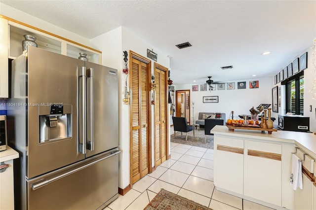 14680 SW 107th Ter, Miami, FL 33186 - kitchen featuring high end fridge, a ceiling fan, light countertops, light tile patterned floors, and white cabinets