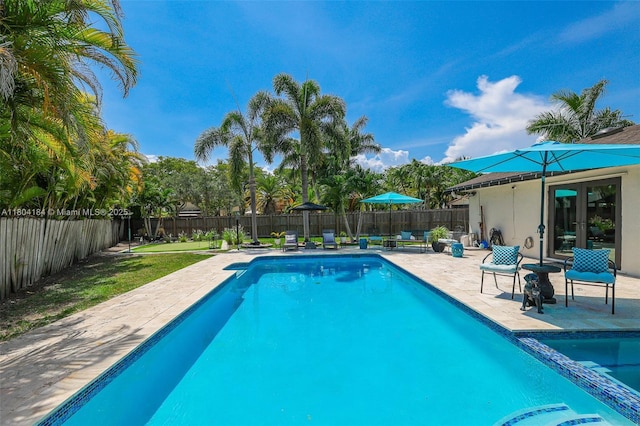 14680 SW 107th Ter, Miami, FL 33186 - view of swimming pool with a patio area, a fenced backyard, and french doors