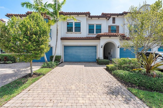 1403 SW 113th Ave, Pembroke Pines, FL 33025 - mediterranean / spanish-style house featuring a tile roof, stucco siding, a garage, and decorative driveway