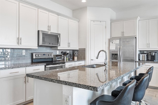 1403 SW 113th Ave, Pembroke Pines, FL 33025 - kitchen with stainless steel appliances, a sink, white cabinets, decorative backsplash, and recessed lighting