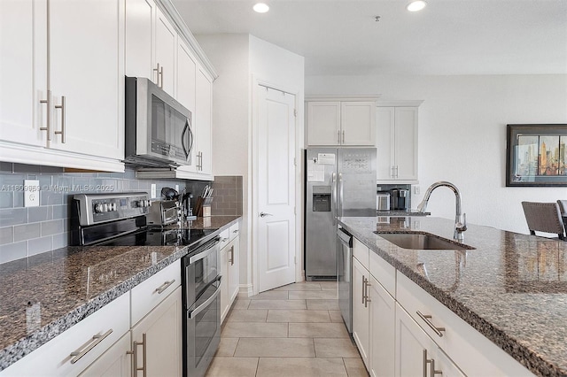 1403 SW 113th Ave, Pembroke Pines, FL 33025 - kitchen featuring appliances with stainless steel finishes, a sink, white cabinets, backsplash, and recessed lighting
