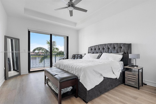 1403 SW 113th Ave, Pembroke Pines, FL 33025 - bedroom featuring access to outside, light wood-type flooring, a raised ceiling, and baseboards