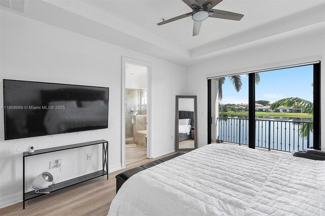 1403 SW 113th Ave, Pembroke Pines, FL 33025 - bedroom featuring access to exterior, wood finished floors, a raised ceiling, a water view, and baseboards