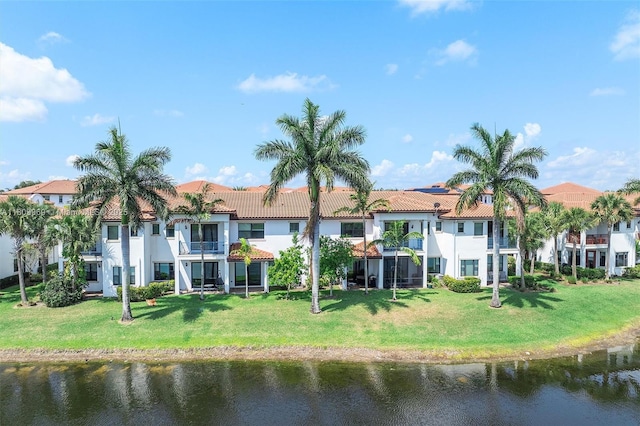 1403 SW 113th Ave, Pembroke Pines, FL 33025 - rear view of house featuring a water view, a tile roof, a lawn, stucco siding, and a residential view