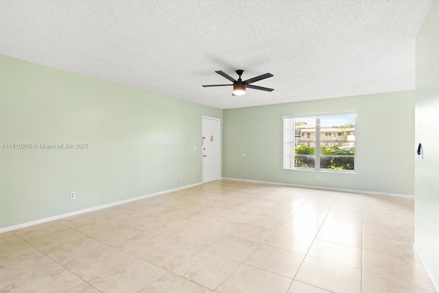 20 Lake Vista Trl Unit 107, Port St Lucie, FL 34952 - tiled spare room with ceiling fan, a textured ceiling, and baseboards