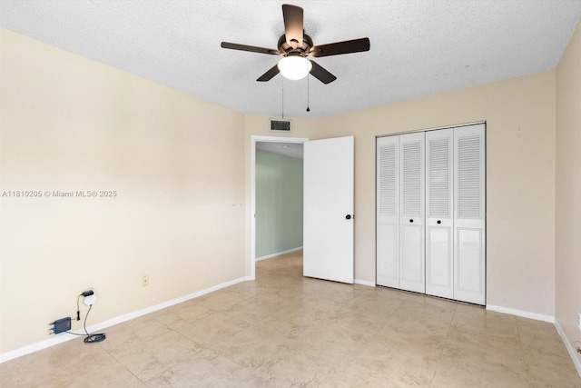 20 Lake Vista Trl Unit 107, Port St Lucie, FL 34952 - unfurnished bedroom featuring baseboards, a closet, a textured ceiling, and a ceiling fan