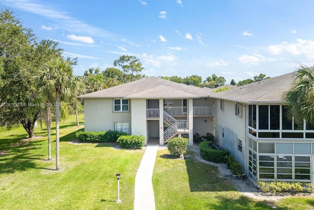 20 Lake Vista Trl Unit 107, Port St Lucie, FL 34952 - view of front of property featuring stucco siding, a front lawn, and stairs