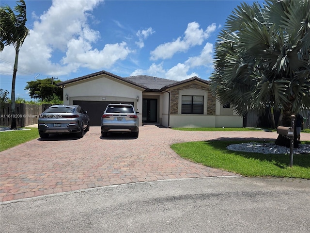21305 SW 177th Ct, Miami, FL 33187 - ranch-style house with decorative driveway, a garage, stucco siding, stone siding, and a tile roof