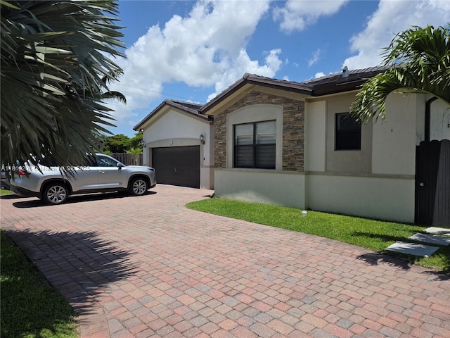 21305 SW 177th Ct, Miami, FL 33187 - ranch-style house with a garage, stucco siding, stone siding, decorative driveway, and a tile roof