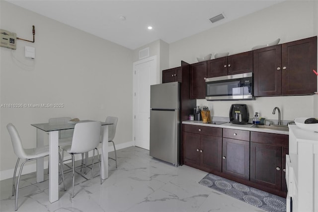 21305 SW 177th Ct, Miami, FL 33187 - kitchen featuring stainless steel appliances, light marble finish floors, light countertops, and recessed lighting