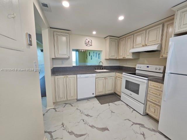 900 Colony Point Cir Unit 505, Pembroke Pines, FL 33026 - kitchen with white appliances, under cabinet range hood, light marble finish floors, recessed lighting, and a sink