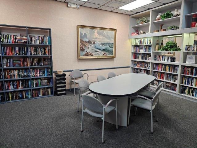 900 Colony Point Cir Unit 505, Pembroke Pines, FL 33026 - carpeted office space with wall of books and a drop ceiling