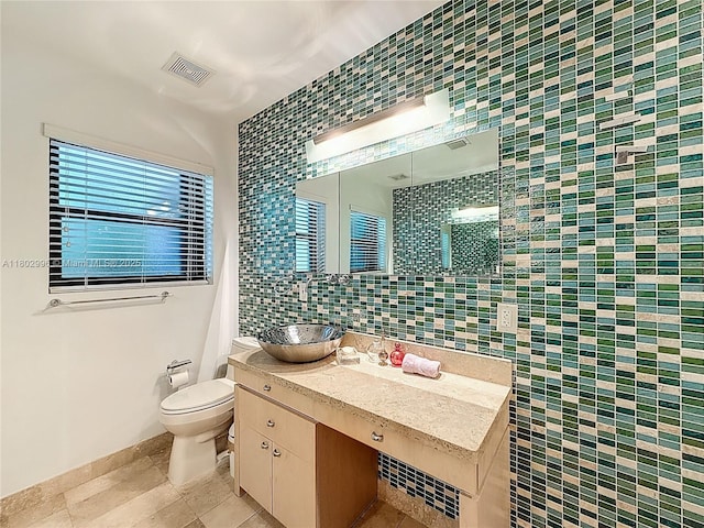 2810 Crystal Ct, Miami, FL 33133 - bathroom featuring tile patterned flooring, toilet, vanity, tile walls, and backsplash