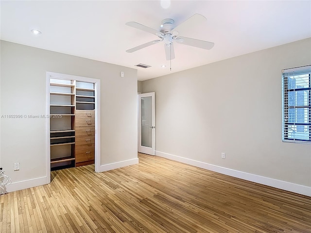 2810 Crystal Ct, Miami, FL 33133 - unfurnished bedroom with light wood finished floors, baseboards, a closet, and ceiling fan