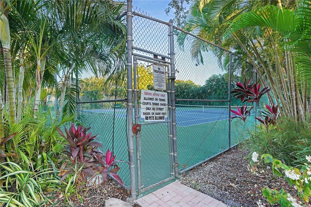 760 E Coco Plum Cir, Plantation, FL 33324 - view of tennis court with a gate