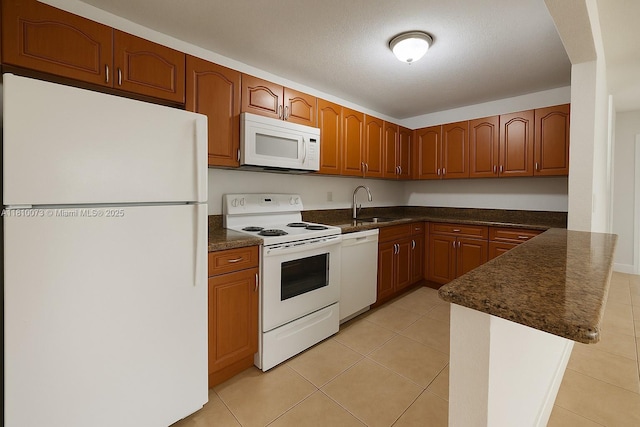 4660 NW 79th Ave Unit 1C, Doral, FL 33166 - kitchen with white appliances, a sink, a peninsula, brown cabinets, and light tile patterned floors