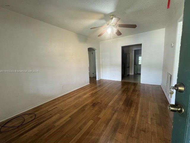 218 SW 10th St, Fort Lauderdale, FL 33315 - unfurnished room featuring arched walkways, ceiling fan, hardwood / wood-style floors, a textured ceiling, and baseboards