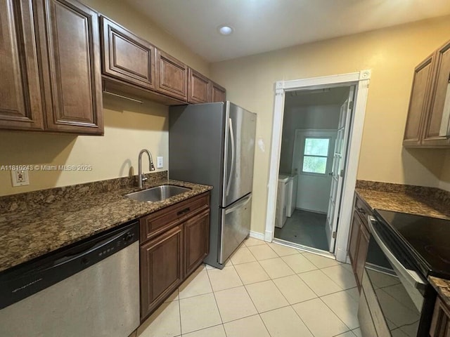 218 SW 10th St, Fort Lauderdale, FL 33315 - kitchen featuring appliances with stainless steel finishes, a sink, dark stone countertops, light tile patterned floors, and recessed lighting