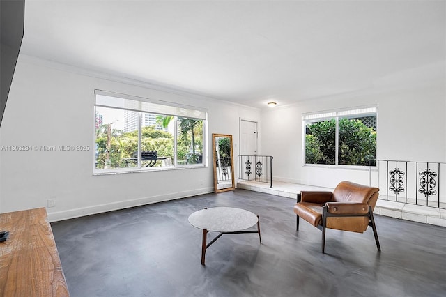 1884 Galleon St Unit 1, North Bay Village, FL 33141 - living area featuring concrete flooring, crown molding, and baseboards