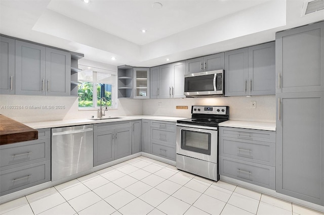 1884 Galleon St Unit 1, North Bay Village, FL 33141 - kitchen featuring stainless steel appliances, gray cabinets, a sink, open shelves, and recessed lighting