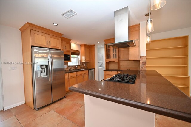 16320 SW 100th Ct, Miami, FL 33157 - kitchen with appliances with stainless steel finishes, stacked washing machine and dryer, exhaust hood, a sink, and a peninsula