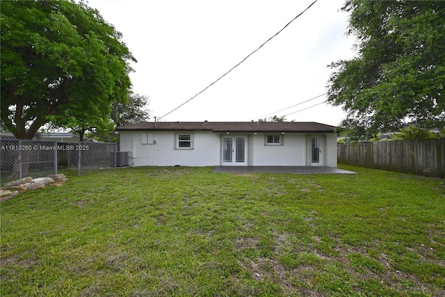 16320 SW 100th Ct, Miami, FL 33157 - back of house featuring french doors, stucco siding, central AC unit, and a patio area