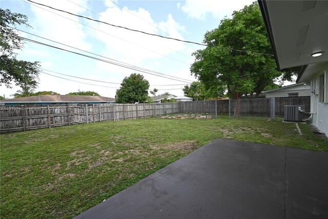 16320 SW 100th Ct, Miami, FL 33157 - view of yard with central air condition unit and a patio