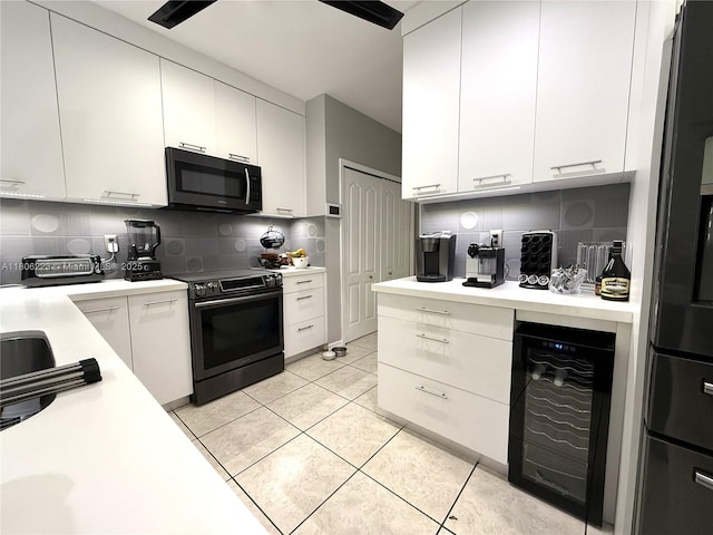 9772 SW 159th Ave, Miami, FL 33196 - kitchen featuring stainless steel range with electric cooktop, wine cooler, light countertops, and tasteful backsplash