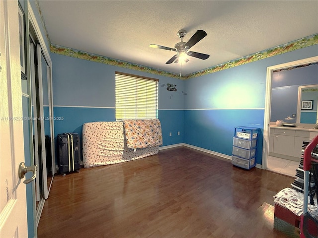 9772 SW 159th Ave, Miami, FL 33196 - unfurnished bedroom featuring wood finished floors, a textured ceiling, baseboards, and a ceiling fan