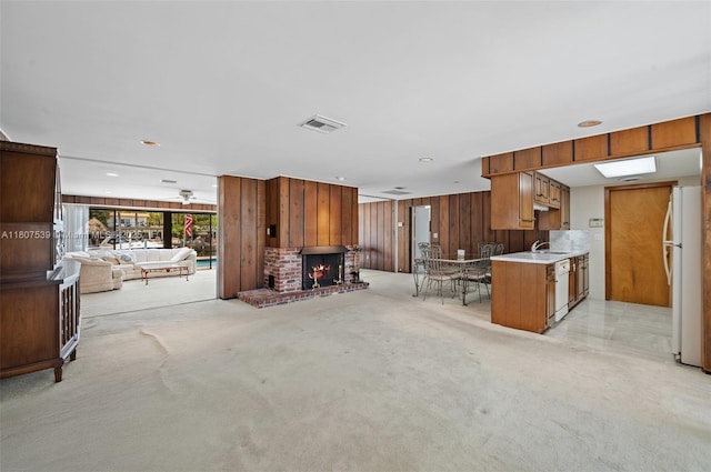 4465 SW 37th Ave, Dania Beach, FL 33312 - unfurnished living room with a sink, light colored carpet, wood walls, and a fireplace