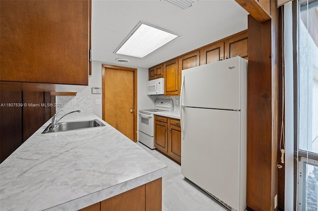 4465 SW 37th Ave, Dania Beach, FL 33312 - kitchen featuring white appliances, a sink, light countertops, and brown cabinetry