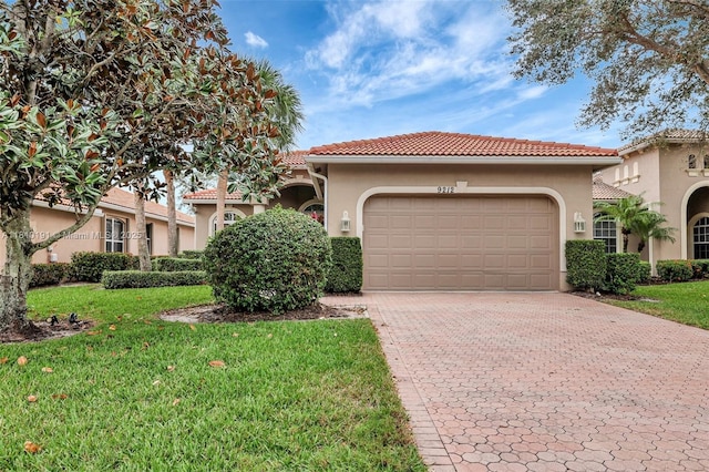 9212 Short Chip Cir, Port St Lucie, FL 34986 - mediterranean / spanish-style house with stucco siding, decorative driveway, a front yard, and a garage