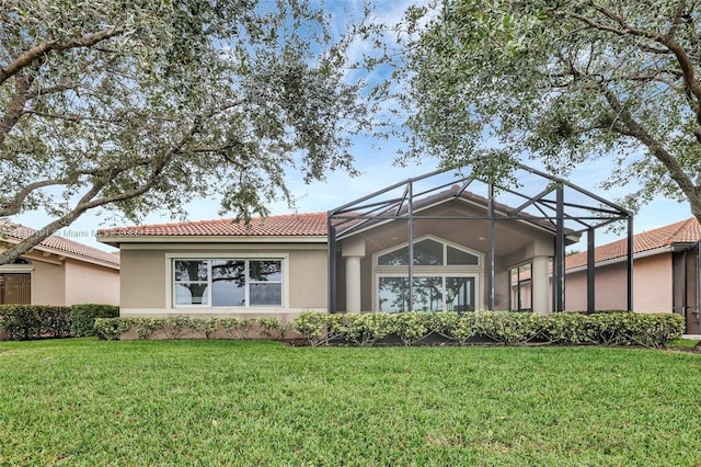 9212 Short Chip Cir, Port St Lucie, FL 34986 - rear view of property with a tile roof, stucco siding, a yard, and glass enclosure