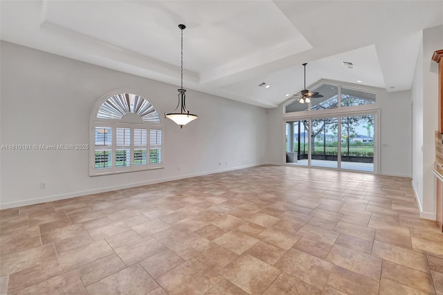 9212 Short Chip Cir, Port St Lucie, FL 34986 - empty room featuring a ceiling fan, baseboards, a tray ceiling, lofted ceiling, and stone finish flooring