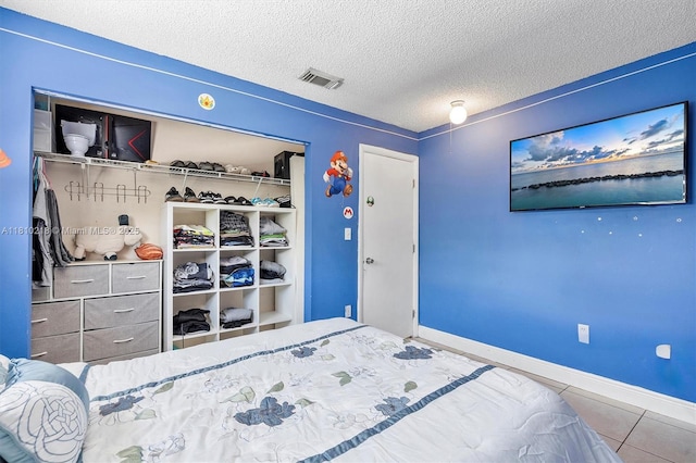 18110 SW 153rd Ct, Miami, FL 33187 - bedroom featuring a closet, a textured ceiling, and tile patterned flooring