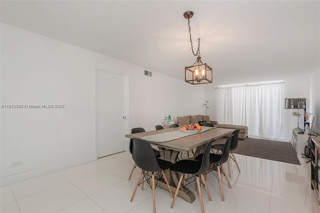 6039 Collins Ave Unit 307, Miami Beach, FL 33140 - dining space with a chandelier