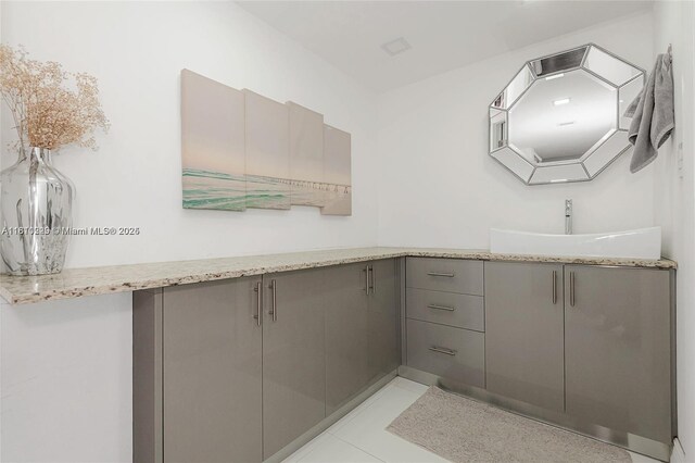 6039 Collins Ave Unit 307, Miami Beach, FL 33140 - bathroom with double vanity and tile patterned flooring