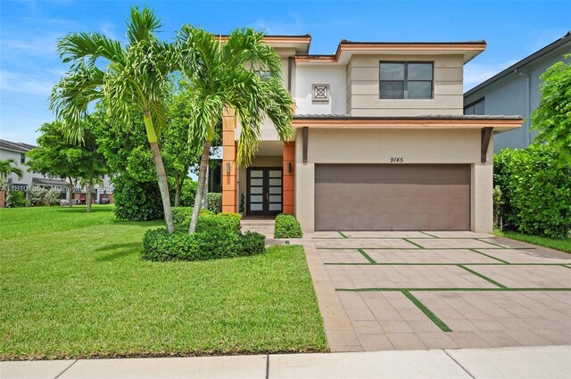 9145 NW 154th Ter, Miami Lakes, FL 33018 - view of front of property with stucco siding, an attached garage, a front lawn, and concrete driveway
