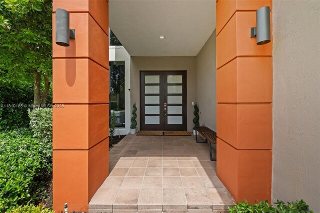 9145 NW 154th Ter, Miami Lakes, FL 33018 - view of exterior entry with french doors and stucco siding
