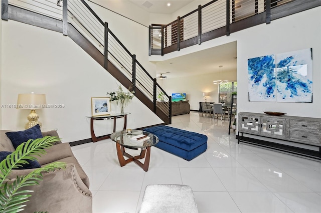 9145 NW 154th Ter, Miami Lakes, FL 33018 - tiled living area with a high ceiling, stairs, and baseboards