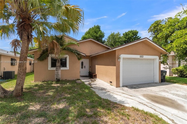 2412 Raleigh St, Hollywood, FL 33020 - view of front of home with stucco siding, cooling unit, a garage, driveway, and a front yard