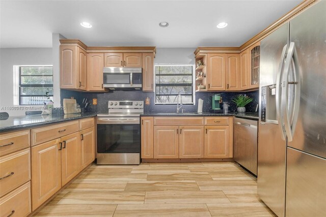 2412 Raleigh St, Hollywood, FL 33020 - kitchen with stainless steel appliances, a sink, dark stone counters, recessed lighting, and backsplash