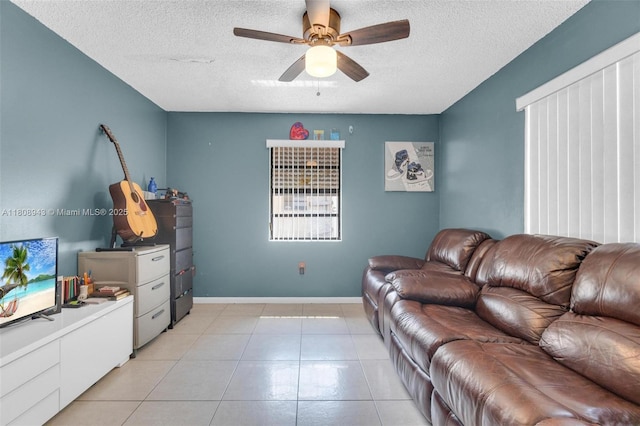 2412 Raleigh St, Hollywood, FL 33020 - living area with a textured ceiling, a ceiling fan, light tile patterned flooring, and baseboards