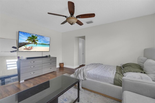 2412 Raleigh St, Hollywood, FL 33020 - bedroom with wood finished floors, baseboards, ceiling fan, and a textured ceiling