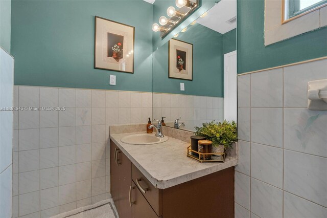 2412 Raleigh St, Hollywood, FL 33020 - bathroom featuring vanity, tile walls, and wainscoting
